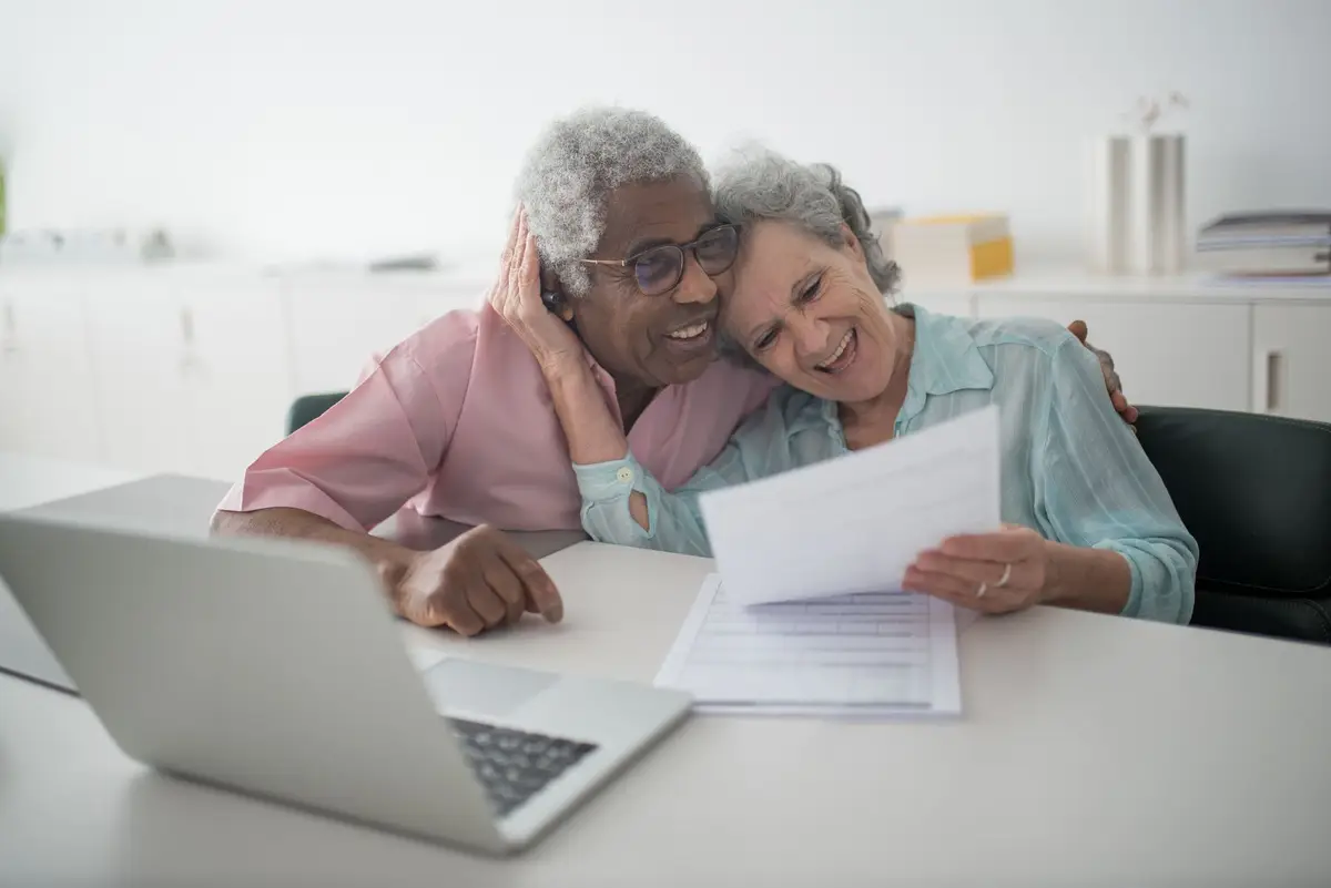 An older couple reviewing paperwork together at a table